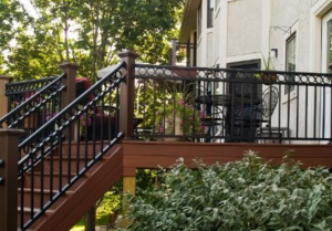 custom wrought iron deck railing and handrails on a large backyard deck with patio furniture