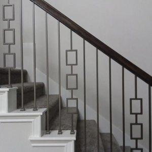 modern design custom wrought iron railing on an interior staircase with carpeted stairs