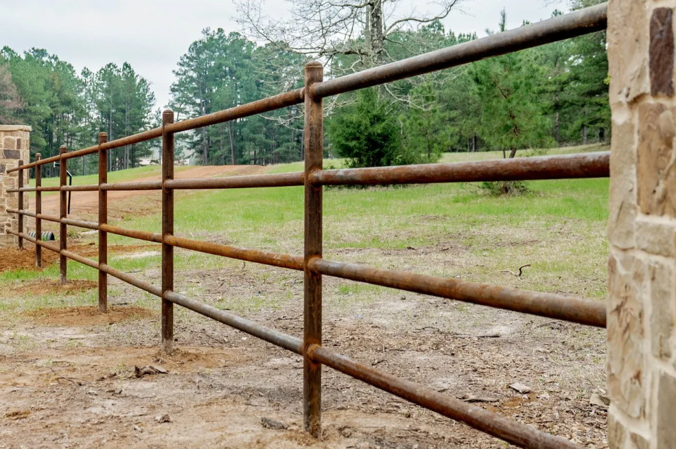 rusty iron perimeter fence in need of cleaning and refinishing with powder coating